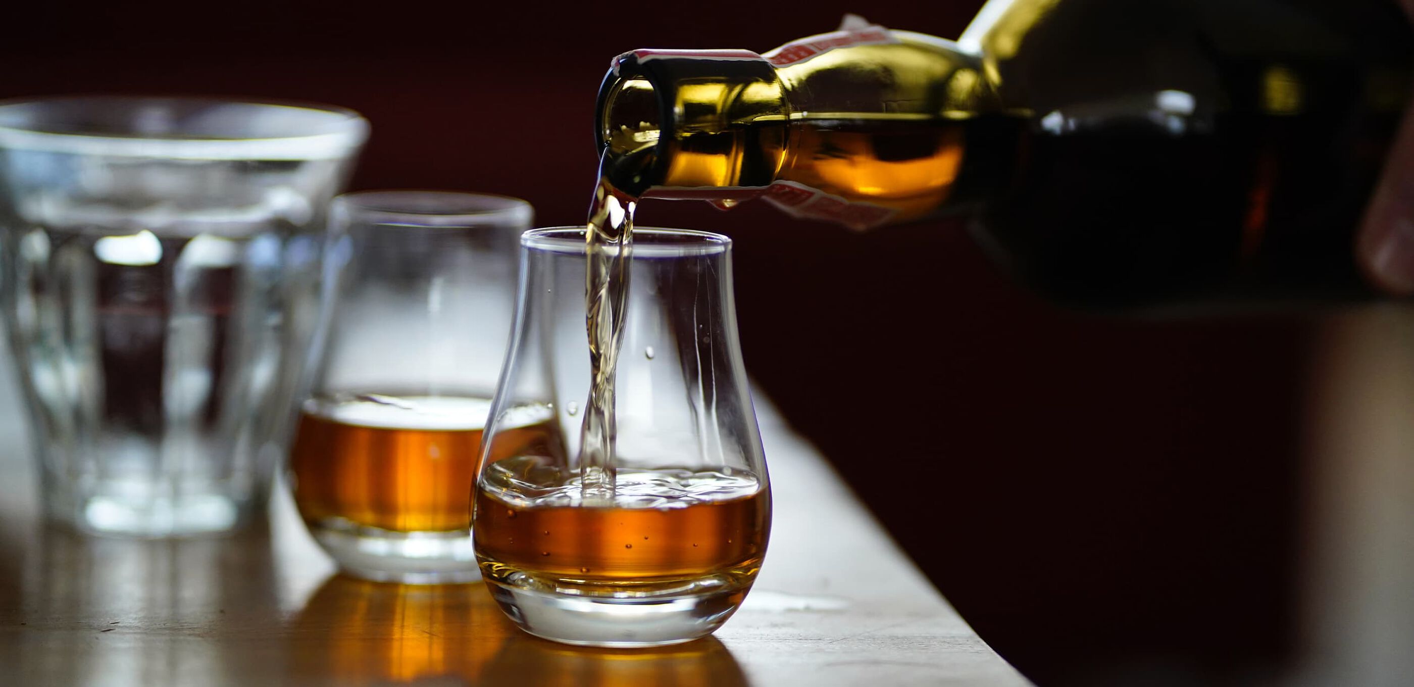 Bourbon being poured into two glasses